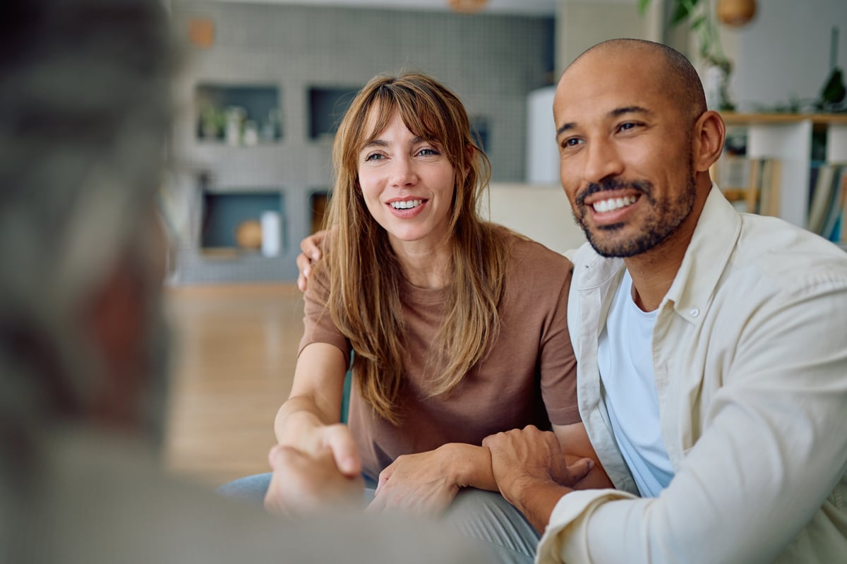 Young couple shaking hands with an insurance consultant about renters coverage